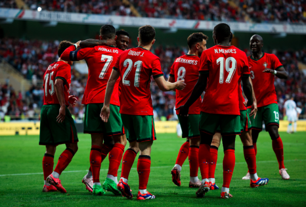 Portugal team jubilate with Ronaldo after his brace in the night game against Ireland
